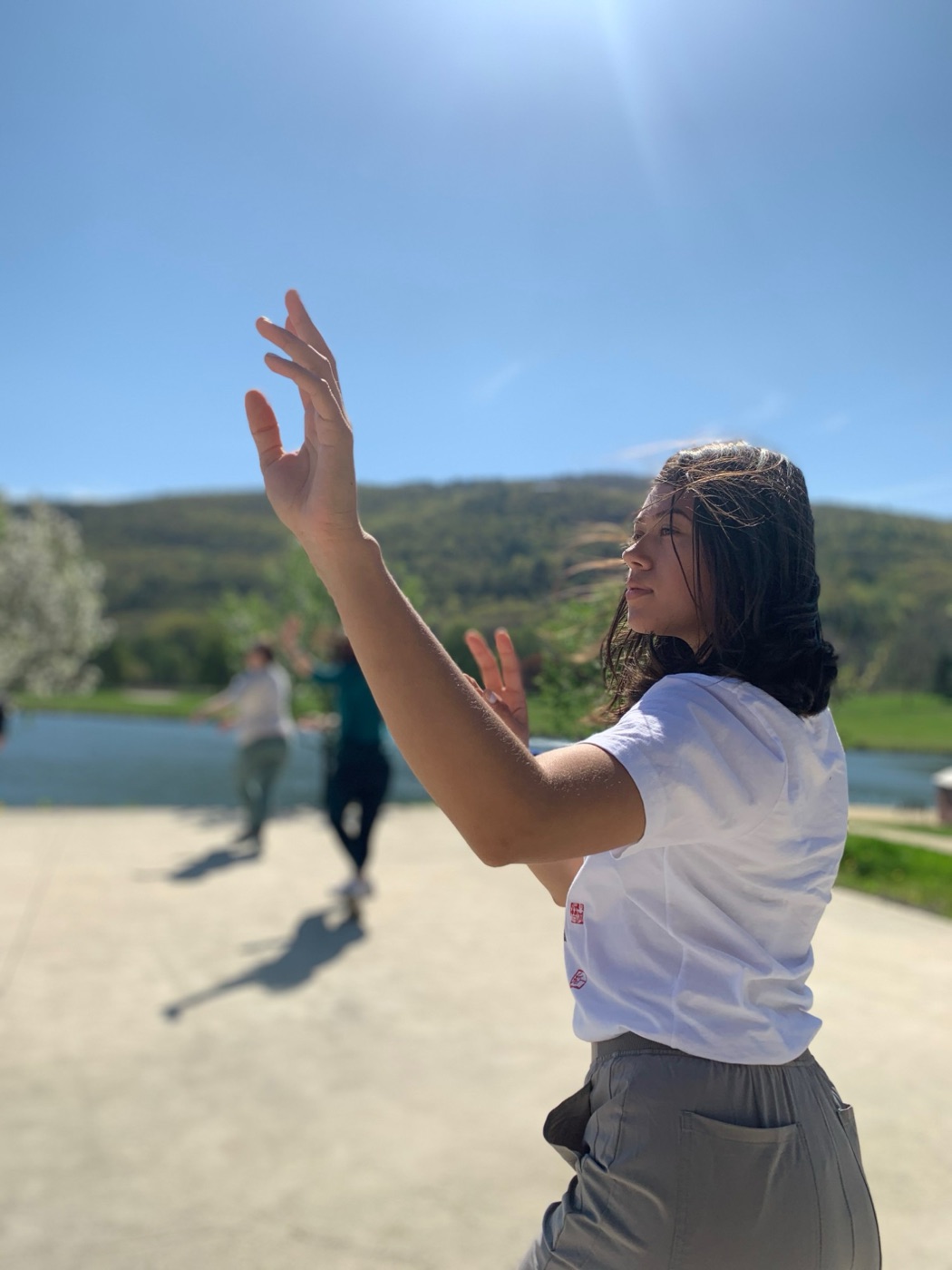 Brittany practicing qigong outdoors in the sun